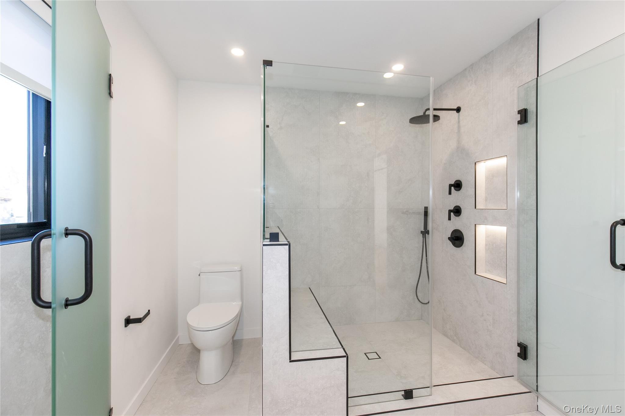 1 Bentley Road Great Neck, NY 11023 - Photo 25 of 34 a bathroom with a shower a toilet and a shower