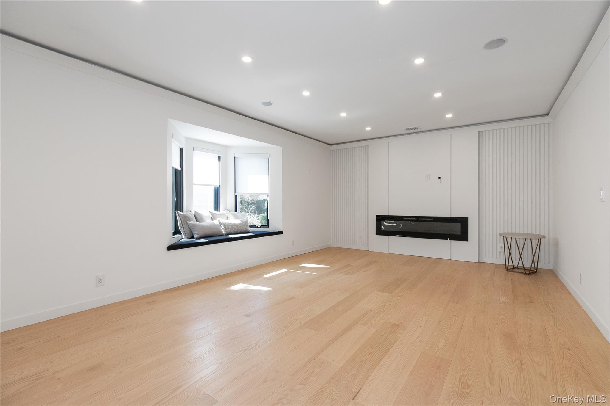 1 Bentley Road Great Neck, NY 11023 - Photo 6 of 34 a view of an empty room with a window and fireplace