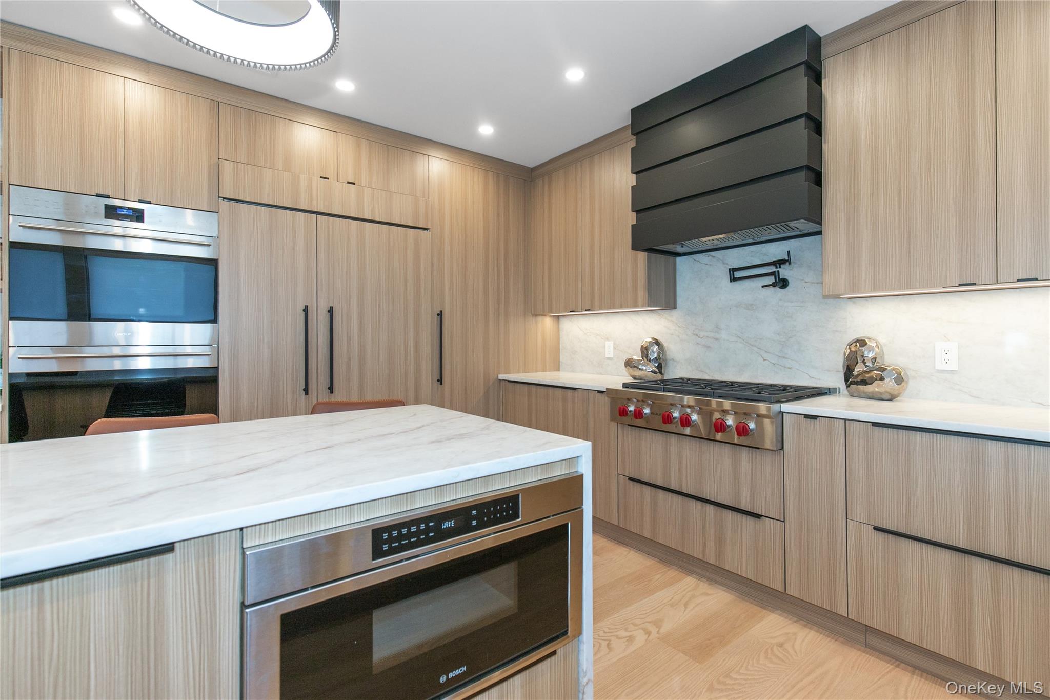 1 Bentley Road Great Neck, NY 11023 - Photo 10 of 34 a kitchen with stainless steel appliances a stove and a refrigerator