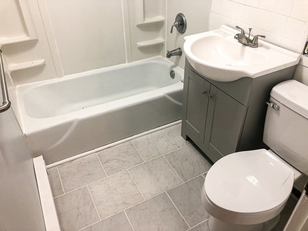 5 Turnpike Road, Unit 210 Townsend, MA 01469 - Photo 11 of 29 a bathroom with a sink a toilet and bathtub