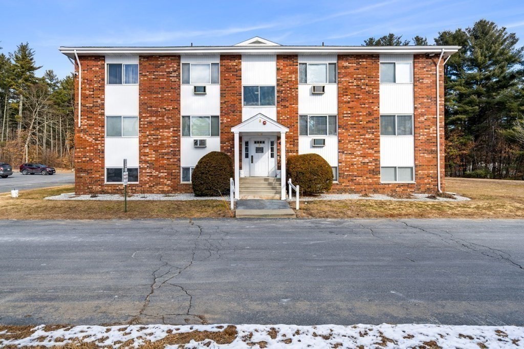 5 Turnpike Road, Unit 210 Townsend, MA 01469 - Photo 18 of 29 a view of a brick house with many windows