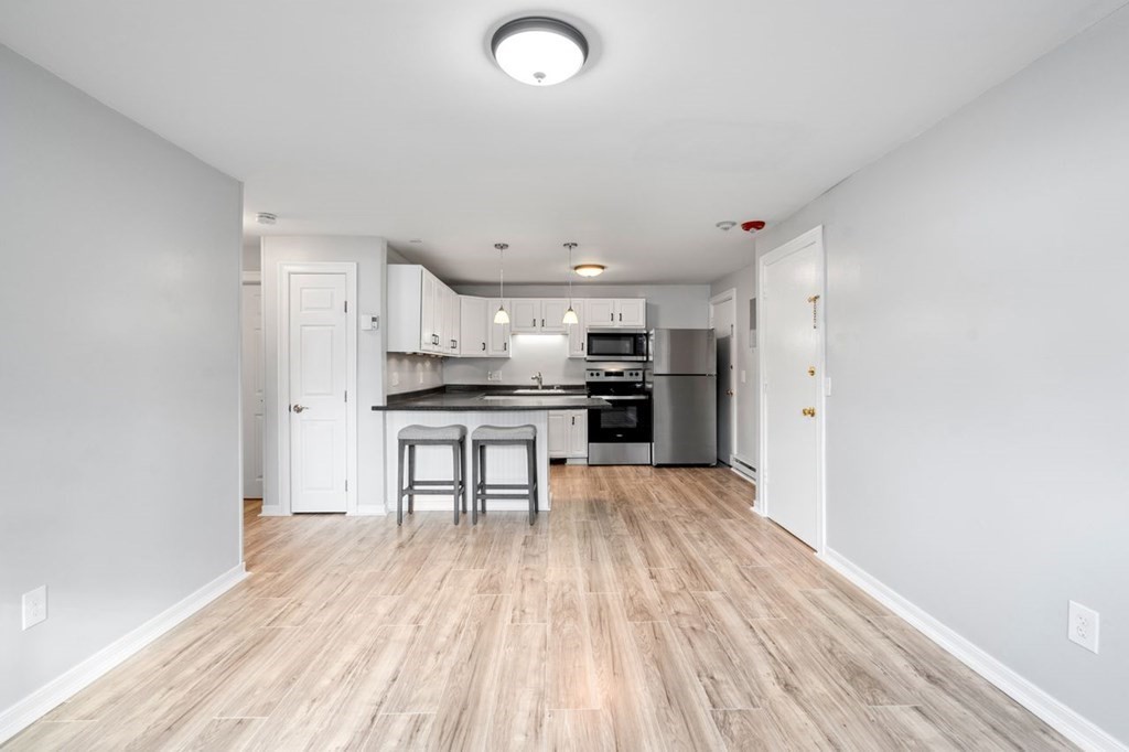 5 Turnpike Road, Unit 210 Townsend, MA 01469 - Photo 6 of 29 a kitchen with stainless steel appliances a refrigerator and a stove top oven