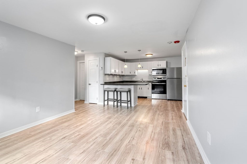 5 Turnpike Road, Unit 210 Townsend, MA 01469 - Photo 7 of 29 a kitchen with stainless steel appliances a refrigerator and a stove top oven