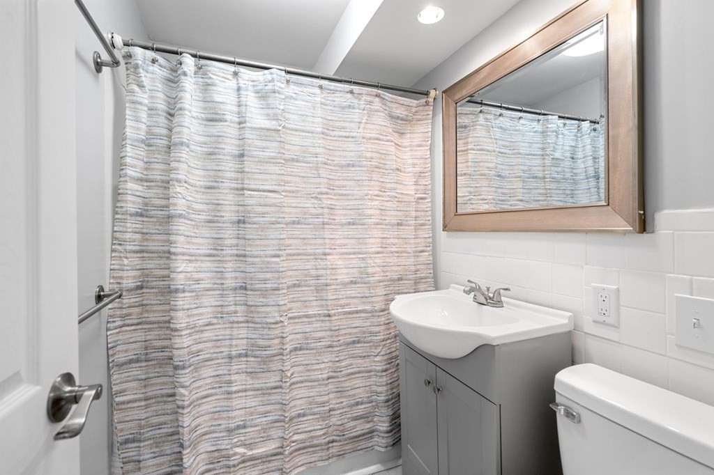 5 Turnpike Road, Unit 210 Townsend, MA 01469 - Photo 10 of 29 a bathroom with a sink a toilet and shower