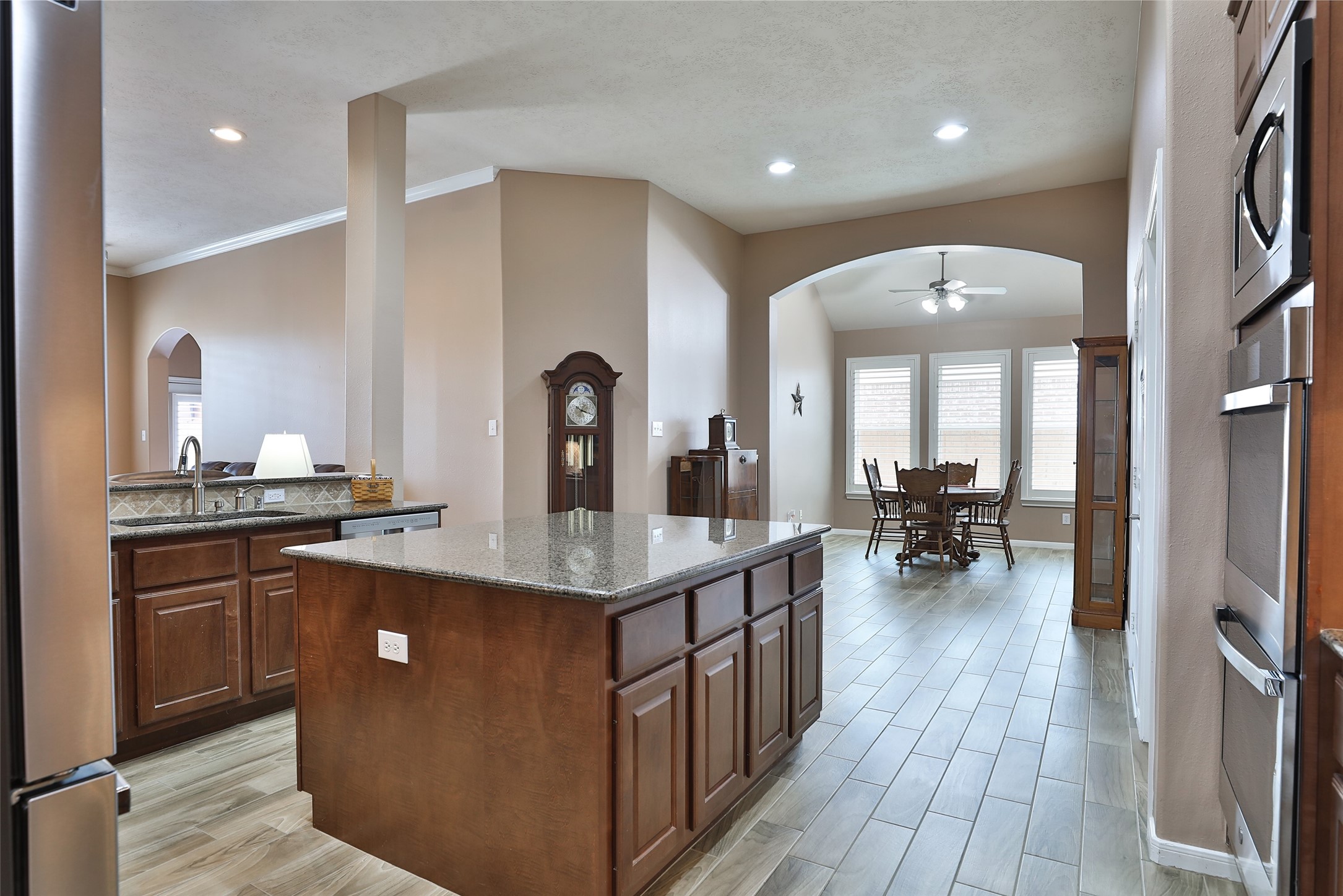 20519 Windrose Bend Drive Spring, TX 77379 - Photo 12 of 37 Whether your the one cooking or the one who keeps the cook company, this kitchen is for you! Featuring an abundance of cabinetry and counter space. Equipped with premium stainless-steel GE appliances, including upgraded double ovens and a spacious island, this kitchen serves as the true heart of the home.