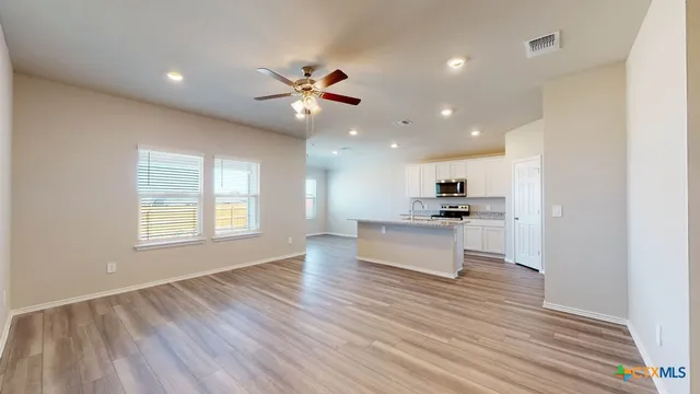 a view of kitchen with refrigerator and window