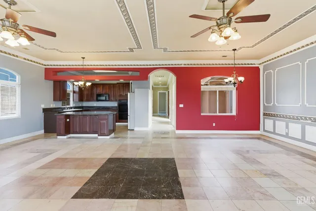 a kitchen with stainless steel appliances granite countertop a refrigerator a sink and a stove