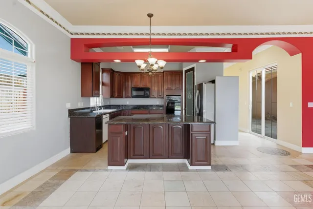 a kitchen with a refrigerator sink and stove