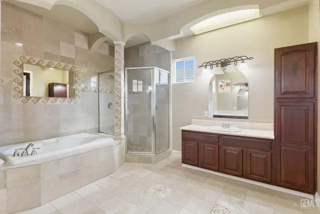 a bedroom with a large bed and a chandelier