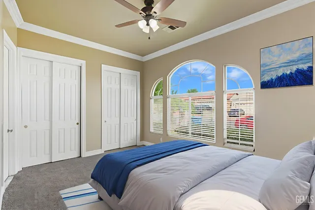 a view of an empty room with a window and a ceiling fan