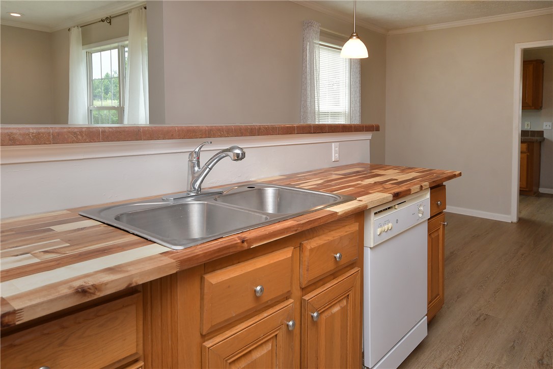 579 Daventon Road Honea Path, SC 29654 - Photo 19 of 44 Butcher block countertops and a stainless steel sink enhance this functional kitchen.