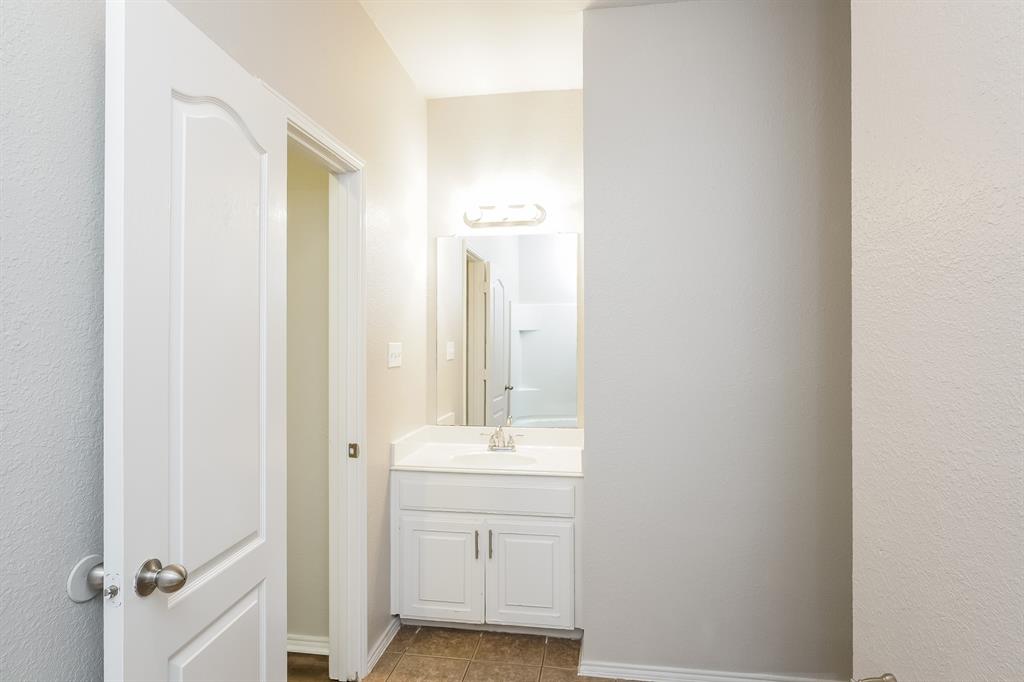 2016 Cattle Creek Road Fort Worth, TX 76134 - Photo 12 of 15 a bathroom with a sink a mirror and a shower