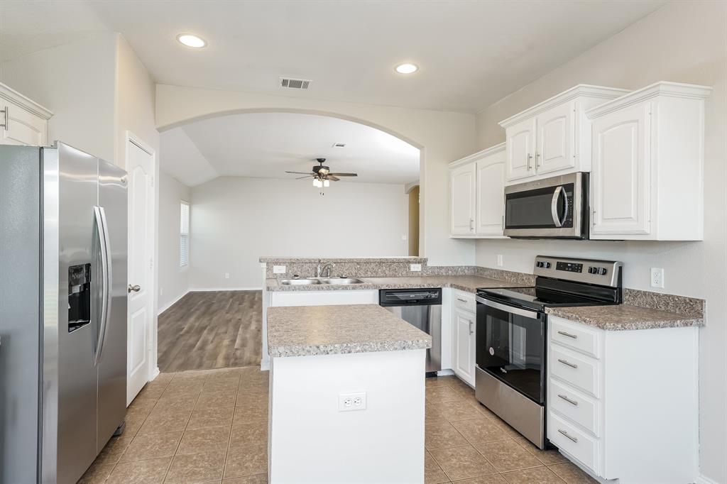 2016 Cattle Creek Road Fort Worth, TX 76134 - Photo 6 of 15 a large kitchen with stainless steel appliances granite countertop a stove and a refrigerator