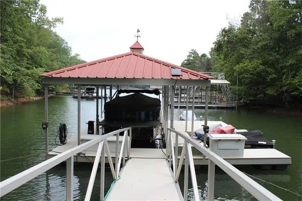 a roof deck with table and chairs a barbeque