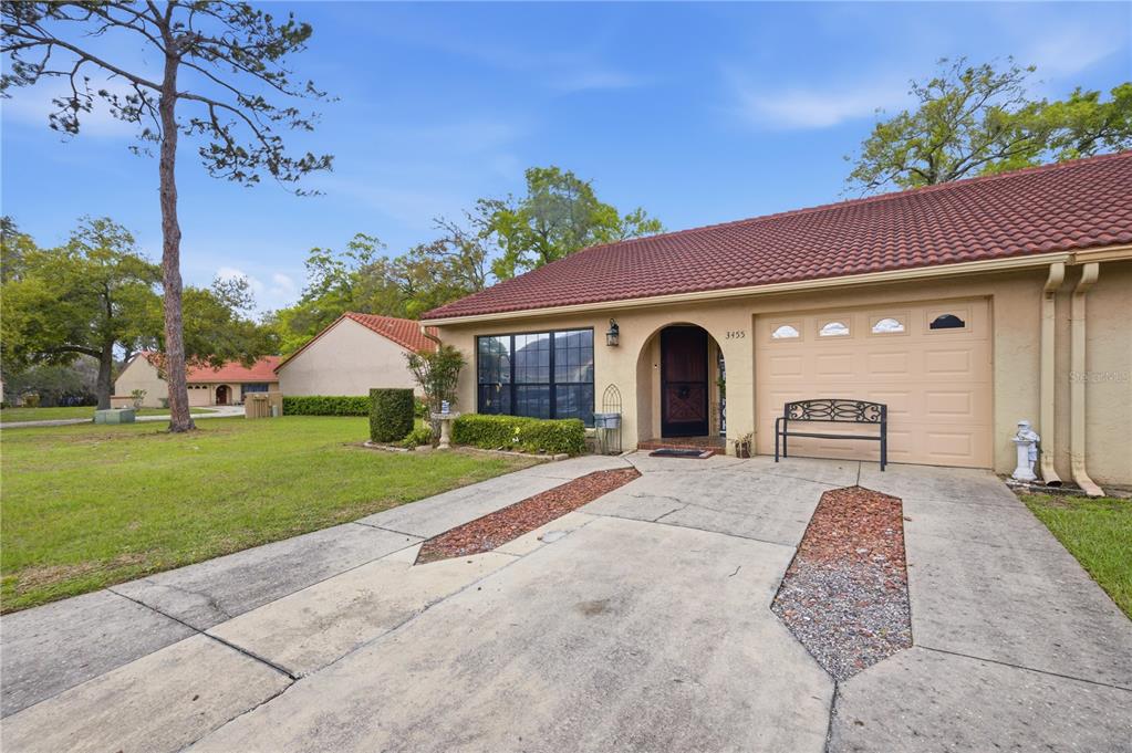 3455 Southwest 19th Street Ocala, FL 34474 - Photo 1 of 17 a front view of a house with garden