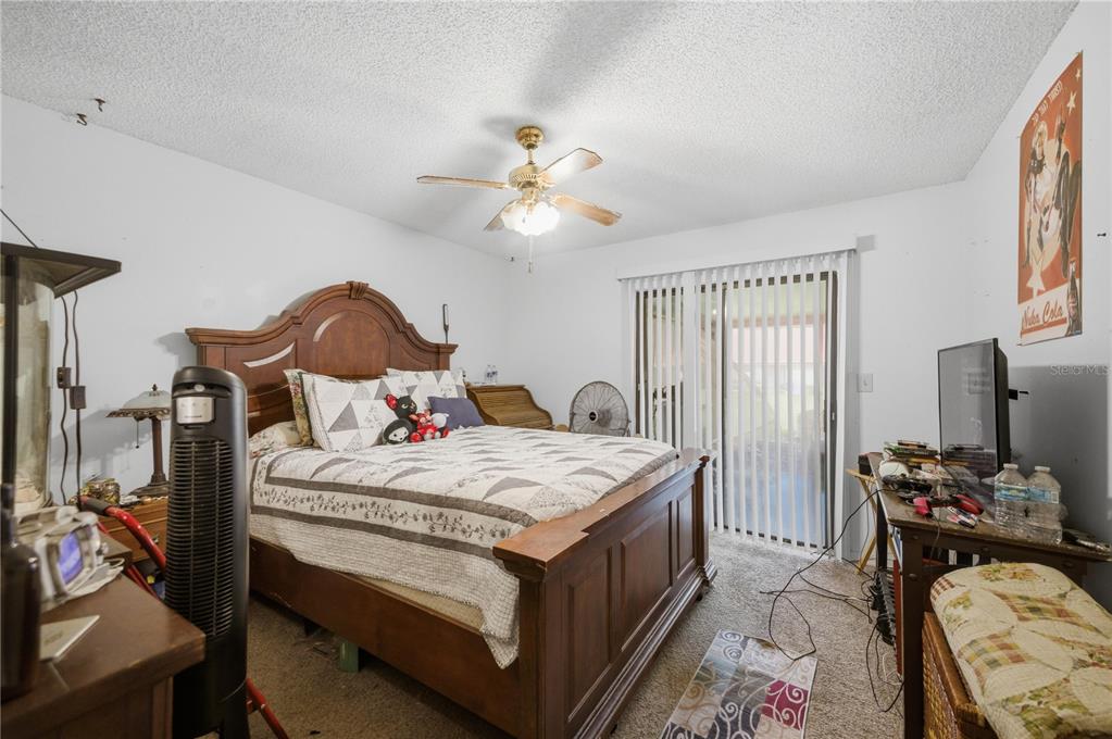 3455 Southwest 19th Street Ocala, FL 34474 - Photo 13 of 17 a bedroom with a bed and a chandelier