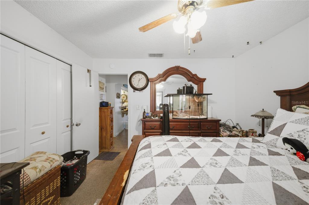 3455 Southwest 19th Street Ocala, FL 34474 - Photo 14 of 17 a bedroom with a bed and a chandelier