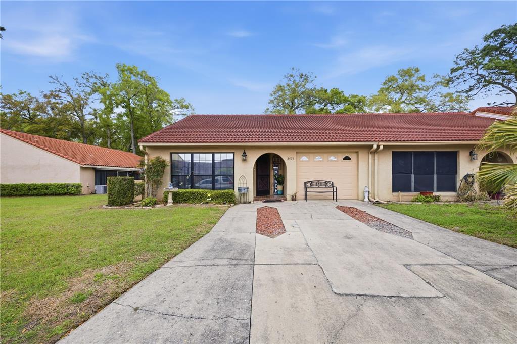 3455 Southwest 19th Street Ocala, FL 34474 - Photo 2 of 17 a front view of a house with a yard and garage