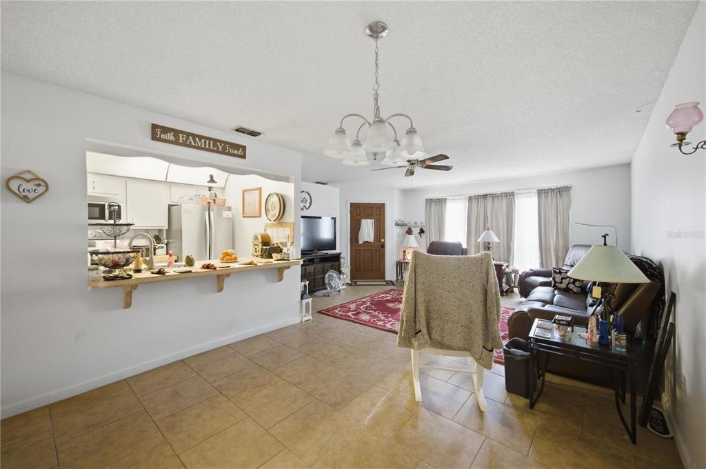 3455 Southwest 19th Street Ocala, FL 34474 - Photo 8 of 17 a living room with furniture and a chandelier