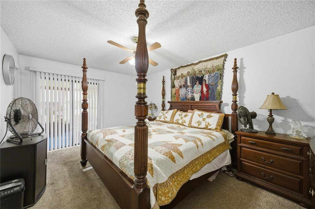 3455 Southwest 19th Street Ocala, FL 34474 - Photo 10 of 17 a bed room with a bed and paintings on the wall