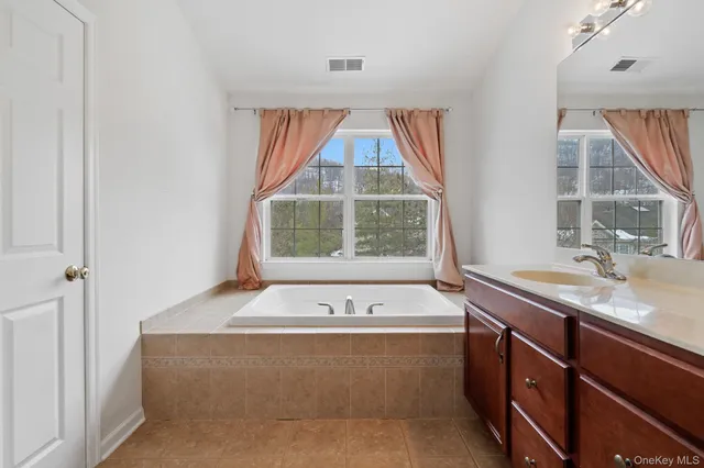 a bathroom with a shower sink and mirror