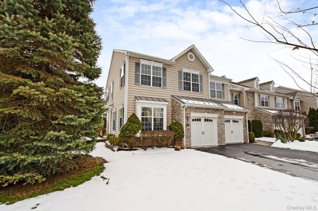 a view of a white house with a yard