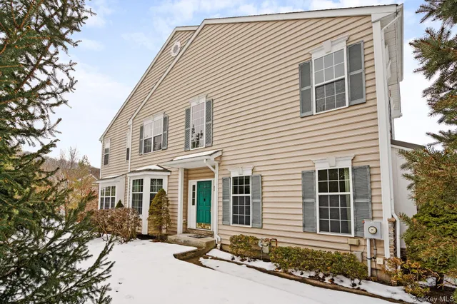 a view of a house with a yard covered in snow