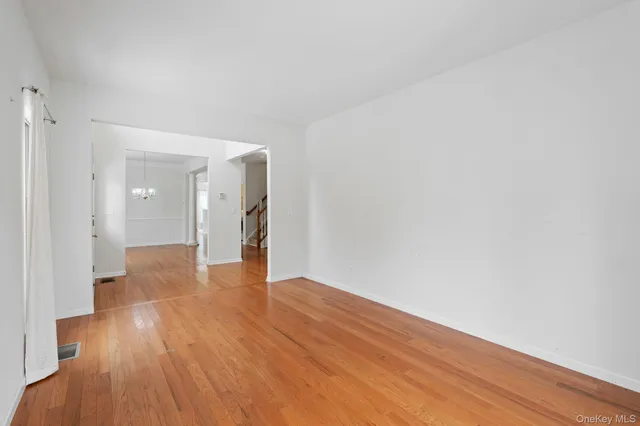a view of an empty room and wooden floor