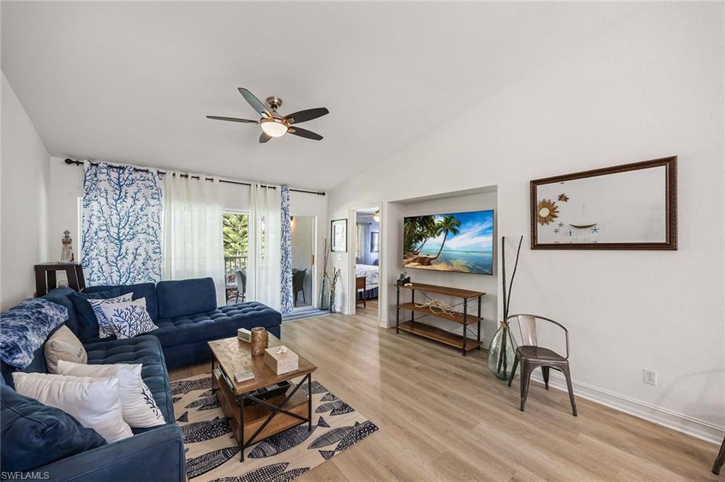 640 Luisa Lane, Unit 8044 Naples, FL 34104 - Photo 11 of 46 a living room with furniture and a wooden floor
