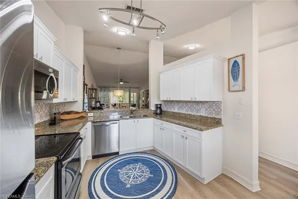 a kitchen with a sink stove and refrigerator