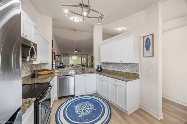 a kitchen with a sink stove and refrigerator