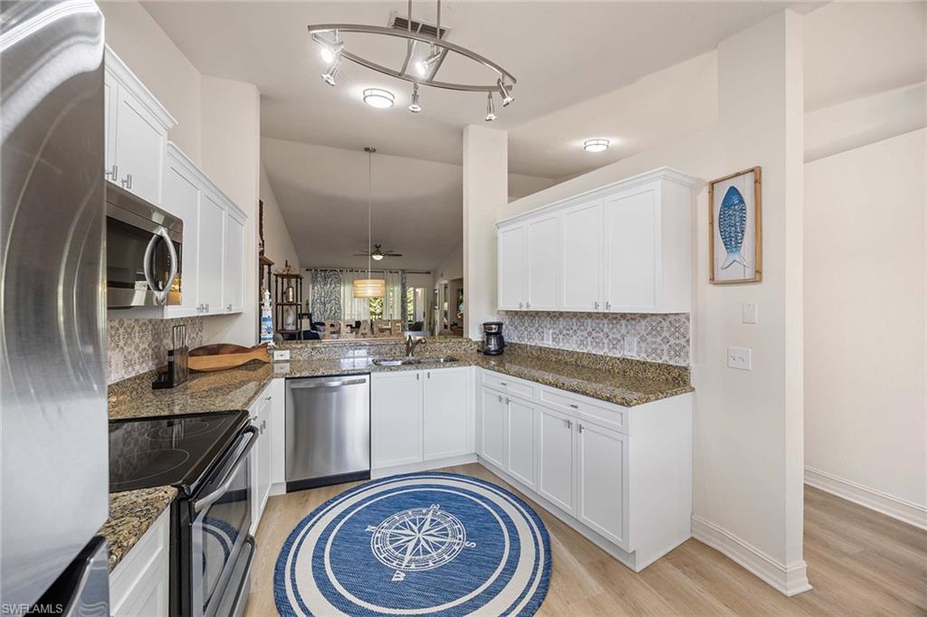 640 Luisa Lane, Unit 8044 Naples, FL 34104 - Photo 16 of 46 a kitchen with a sink stove and refrigerator