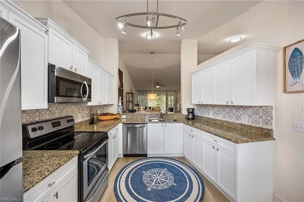 a kitchen with a sink stove and microwave