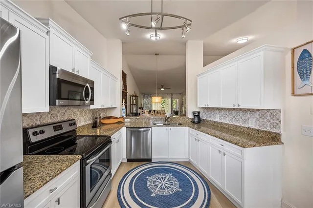 a kitchen with a sink stove and microwave