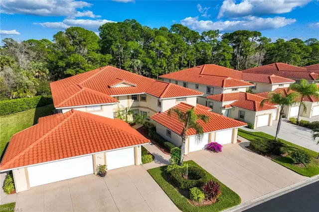 an aerial view of a house with garden space and street view