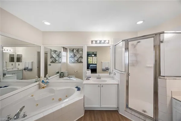 a bathroom with a double vanity sink mirror and shower
