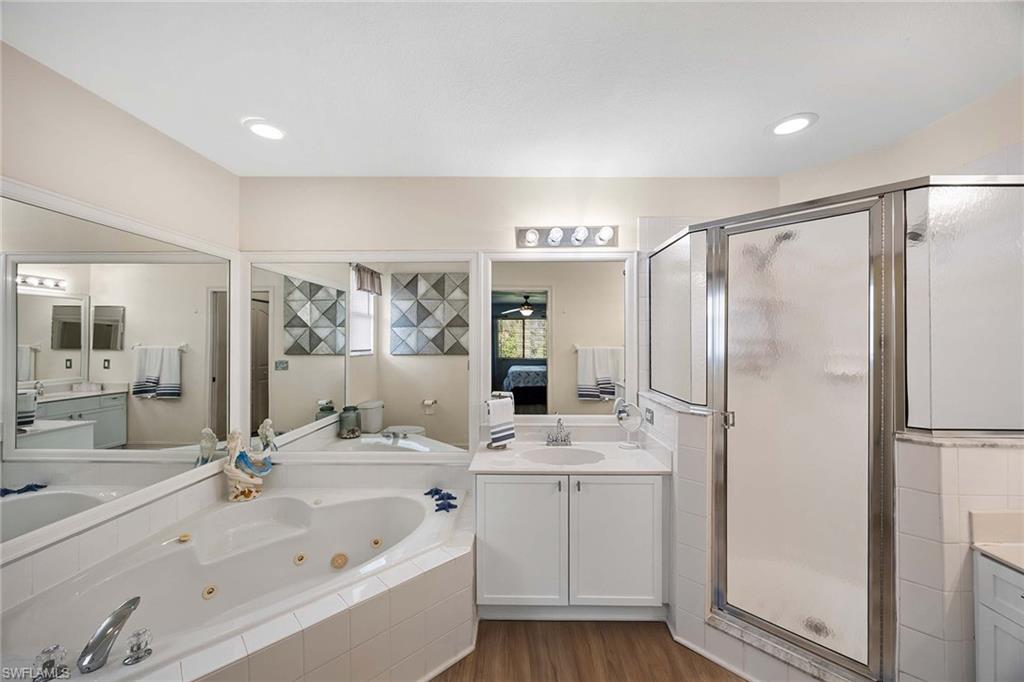 640 Luisa Lane, Unit 8044 Naples, FL 34104 - Photo 22 of 46 a bathroom with a double vanity sink mirror and shower