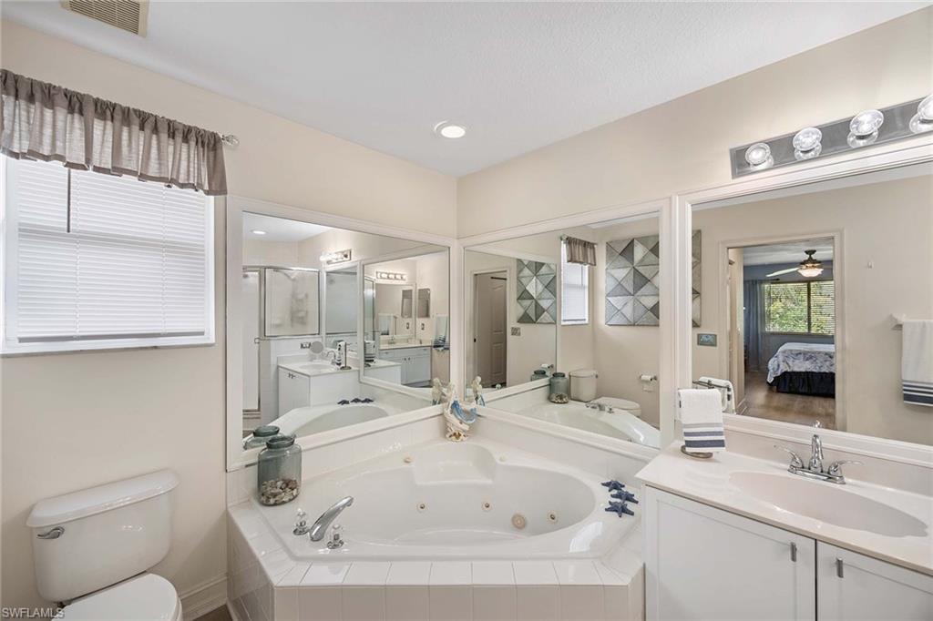 640 Luisa Lane, Unit 8044 Naples, FL 34104 - Photo 24 of 46 a bathroom with a sink a toilet and shower