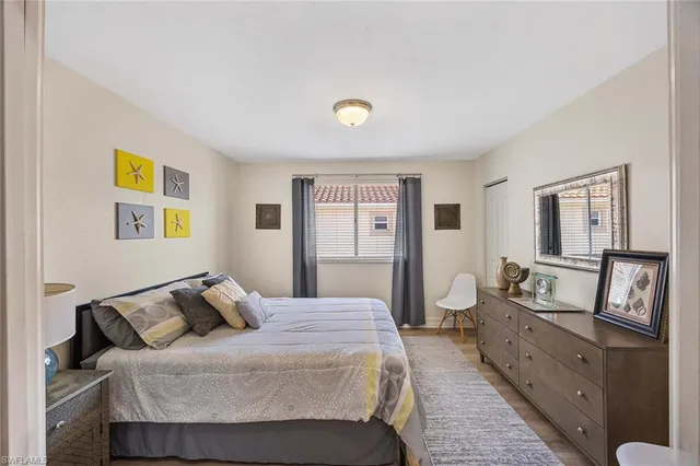 a bedroom with a bed and painting on the wall