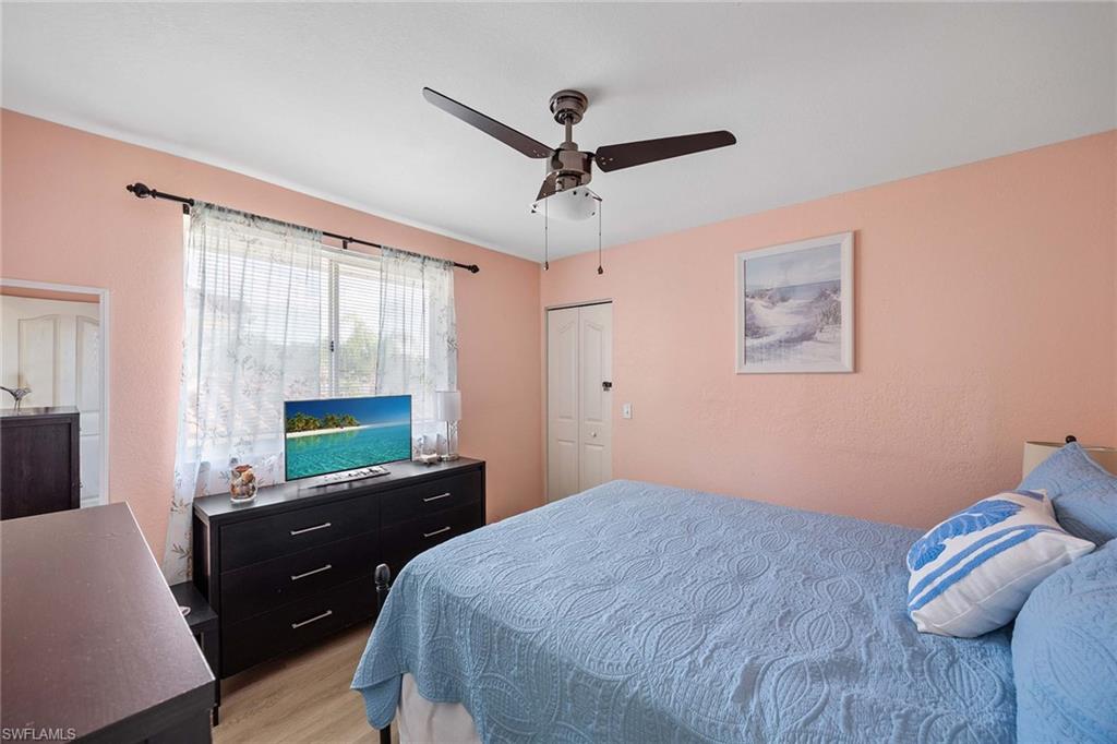 640 Luisa Lane, Unit 8044 Naples, FL 34104 - Photo 28 of 46 a bedroom with a bed window and a desk