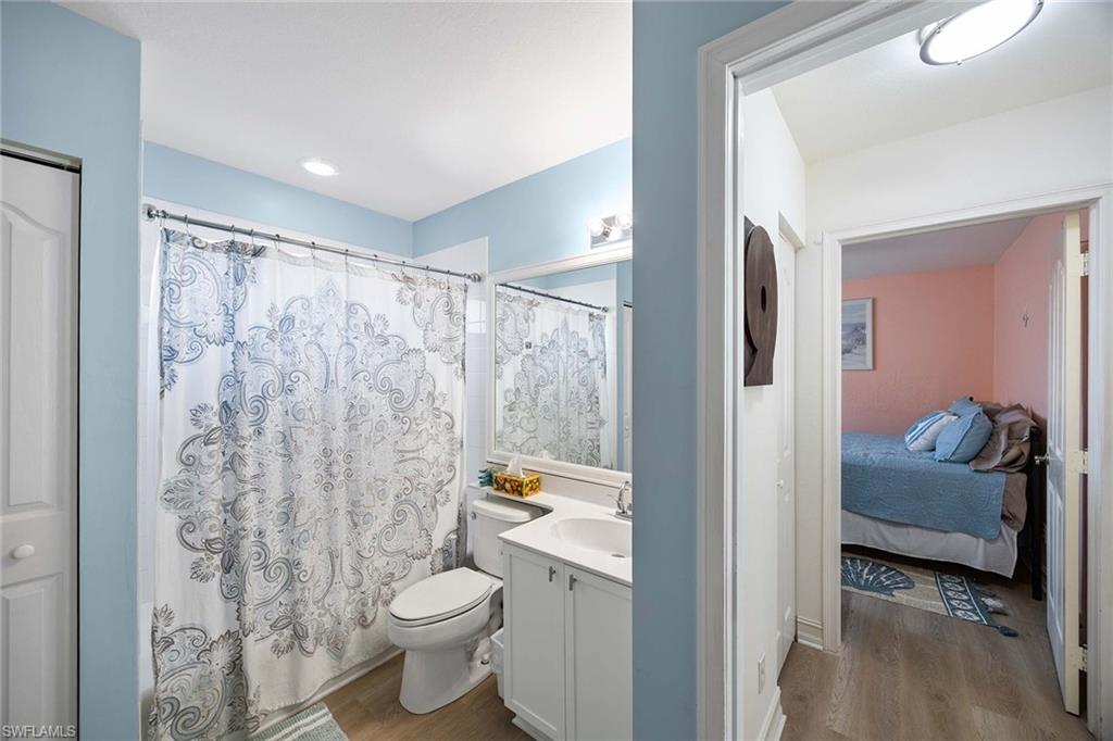 640 Luisa Lane, Unit 8044 Naples, FL 34104 - Photo 29 of 46 a bathroom with a granite countertop sink a toilet and a shower