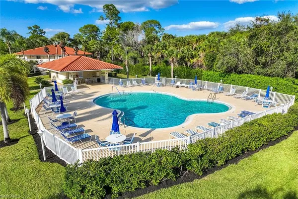 a view of a house with swimming pool and sitting area