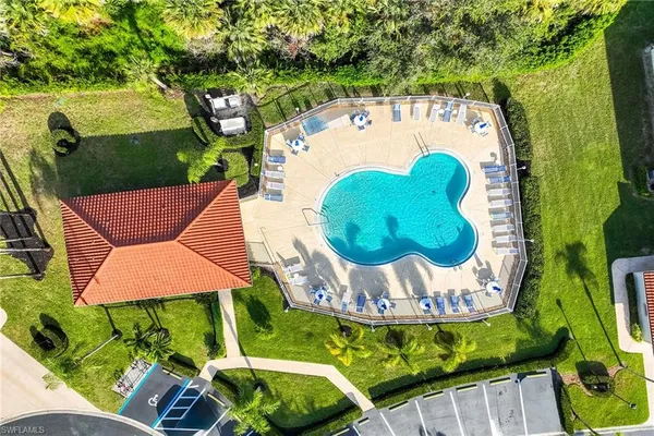 a view of swimming pool with a garden and outdoor seating