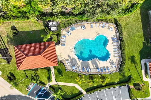 a view of swimming pool with a garden and outdoor seating