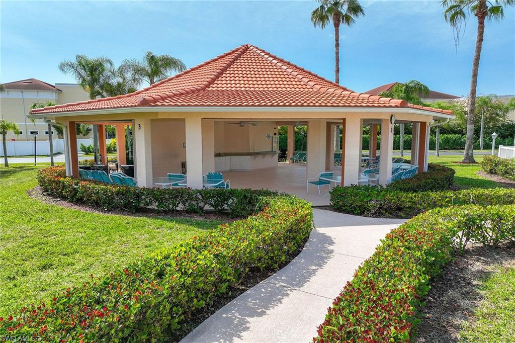 640 Luisa Lane, Unit 8044 Naples, FL 34104 - Photo 42 of 46 a front view of a house with a garden