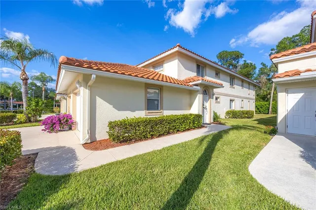 a view of a house with yard and a garden