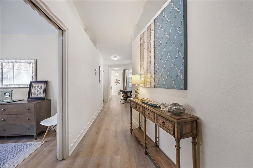 640 Luisa Lane, Unit 8044 Naples, FL 34104 - Photo 7 of 46 a view of a hallway with a livingroom and a window