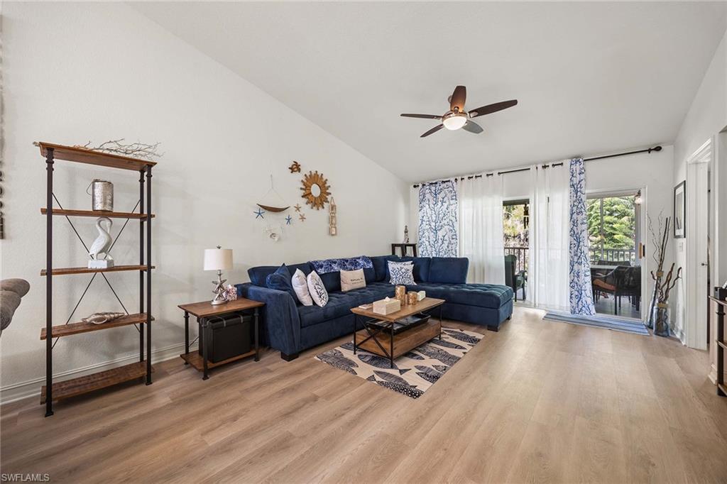 640 Luisa Lane, Unit 8044 Naples, FL 34104 - Photo 8 of 46 a living room with furniture and wooden floor