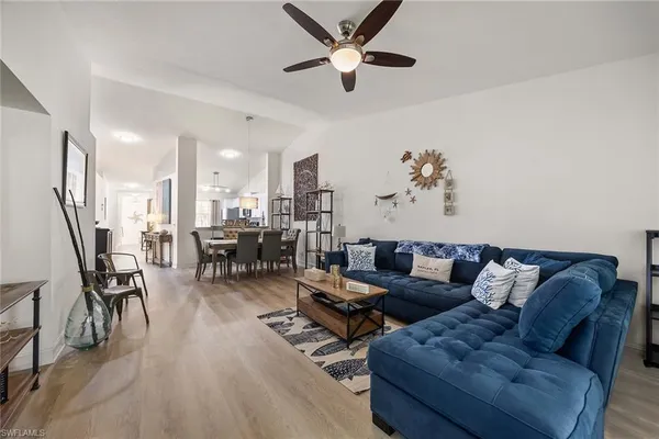 a living room with furniture and kitchen view