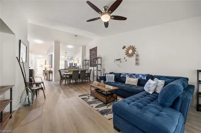 a living room with furniture and kitchen view